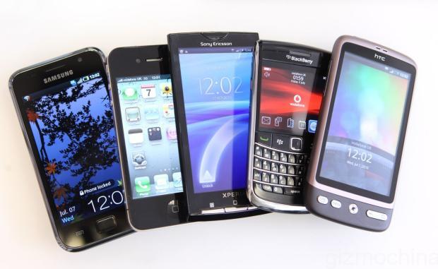 Leading Brands Of Smart Phones...A collection of smartphones, from left, a Samsung Galaxy S, an Apple Inc. iPhone 4, a Sony Ericsson Xperia X10, a Blackberry 9700, and an HTC Desire, are arranged for a photograph in London, U.K., on Wednesday, July 7, 2010. Global smartphone sales will rise 36 percent to 247 million in 2010, ISuppli Corp. said in April. Photographer: Chris Ratcliffe/Bloomberg