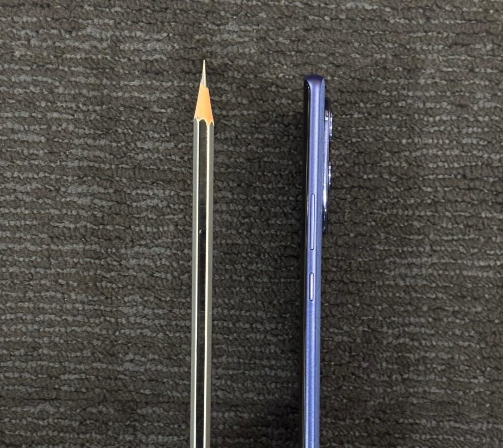 Infinix Note 50s 5G's slimness compared with a pencil