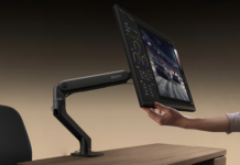 REDMI Monitor Arm launches with five-way adjustment, supports monitors up to 9kg A person adjusts a computer monitor mounted on a flexible black REDMI Monitor Arm.