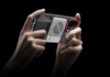 OnePlus launches Magnetic Phone Cooler smaller than a bank card Hands holding a smartphone attached to the OnePlus Magnetic Ice Card Mini Cooler.