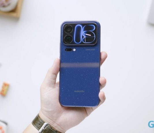 Xiaomi 18 Pro Max Review: Great Phone, but at what cost? A hand holds a blue Xiaomi 18 Pro Max smartphone with a camera island.