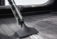 Xiaomi launches portable car vacuum cleaner with 35mm brushless motor and 15000 RPM top speed Xiaomi Mijia Car Vacuum Cleaner cleaning the floor of a vehicle trunk area.