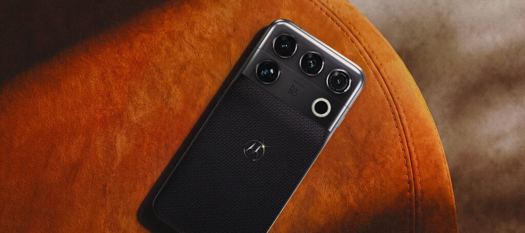 Motorola has put up a dedicated product page for the Motorola Signature 27 on its India website, a clear sign that the flagship's local launch is close. The company already confirmed its India plans at India Mobile Congress earlier this month, and the new microsite now invites buyers to register for updates, with Motorola saying more is "coming this November." The page does not list a price or launch date yet. There is no buy or pre-order button either. Instead, an "A higher standard is coming" email sign-up form points to a November window. What the Motorola Signature 27 India microsite confirms The page bills the Signature 27 as Motorola's fastest Android phone, unveiled at the Qualcomm Tech Summit with an elite-level camera system. It runs on Qualcomm's Snapdragon 8 Elite Extreme Gen 6, which the company says speeds up AI, camera processing, connectivity, and gaming. To keep that chip cool, the phone uses diamond-infused thermal gel and a new 3D vapor chamber. Motorola's global announcement calls this setup ArcticMesh and adds liquid metal and copper mesh to the mix, with a vapor chamber 40% larger than before. On the camera front, the page highlights a 200MP periscope telephoto camera with Super Zoom Pro reaching up to 100x using generative AI. It pairs with a 50MP Sony LYTIA main sensor built for low light and stage shows. Motorola also teases Audio by B&O, making this its first phone tuned by Bang & Olufsen, with sound modes for music, movies, gaming, and podcasts. The phone mixes aerospace-grade aluminum and glass-ceramic, with a Tactical Weave finish and a brushed textile-inspired option. Globally, these arrive as Pantone Coal Smoke and Pantone Capulet Olive. Motorola has also promised seven years of OS upgrades. For context, the original Motorola Signature launched in India at Rs 59,999 (~$630) in January. With a true flagship chip this time, the Signature 27 could sit above it, but Motorola has not shared any pricing yet. Would you pick the Signature 27 over the usual flagship names if Motorola gets the price right?